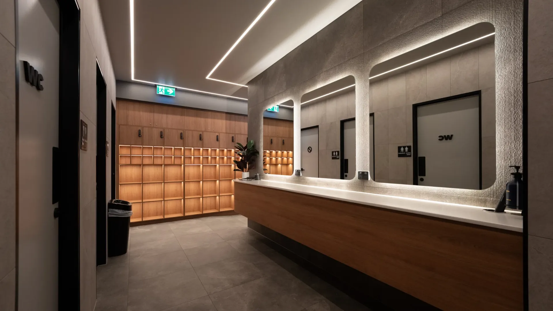 Anytime Fitness changerooms with timber lockers and backlit mirrors