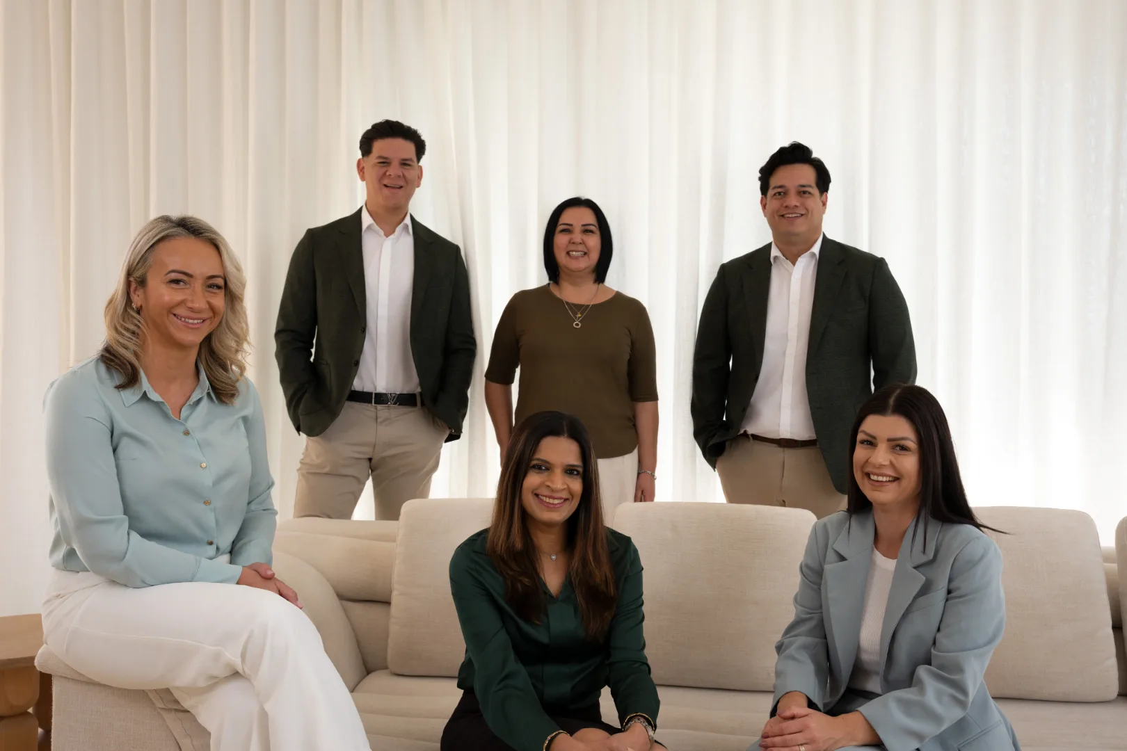 The Do Financial Services team of six photographed together on a cream couch